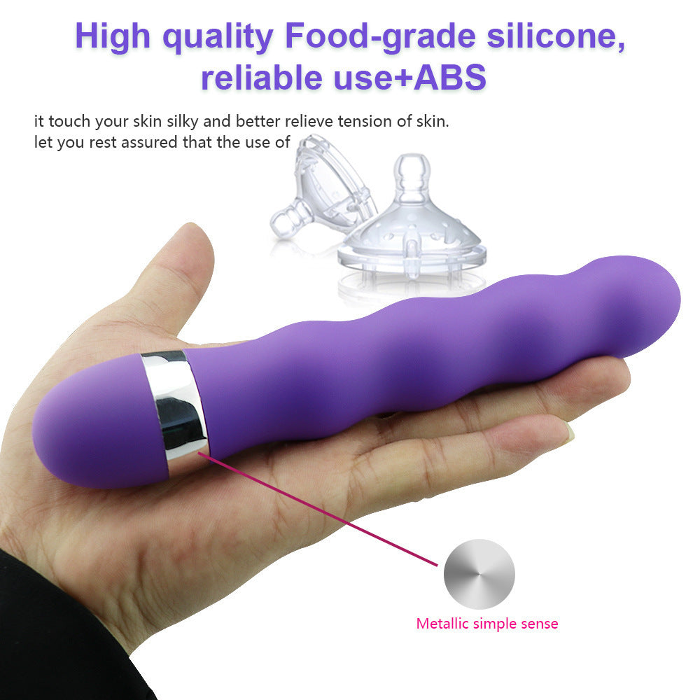 E-27 FlexiGlow vibrator with ergonomic design and flexible body, shown in a neutral setting with close-up of textured surface.