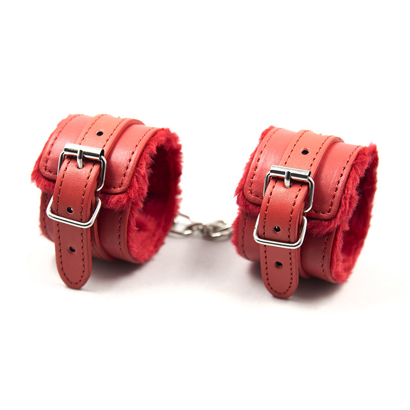 Black BDSM leather bondage set with straps, cuffs, and collar from Dominus Noir, featuring adjustable fittings and D-21 branding.